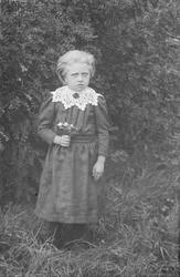 Portrett, Kari Ommundsens barn, jente med blomster i hånden,