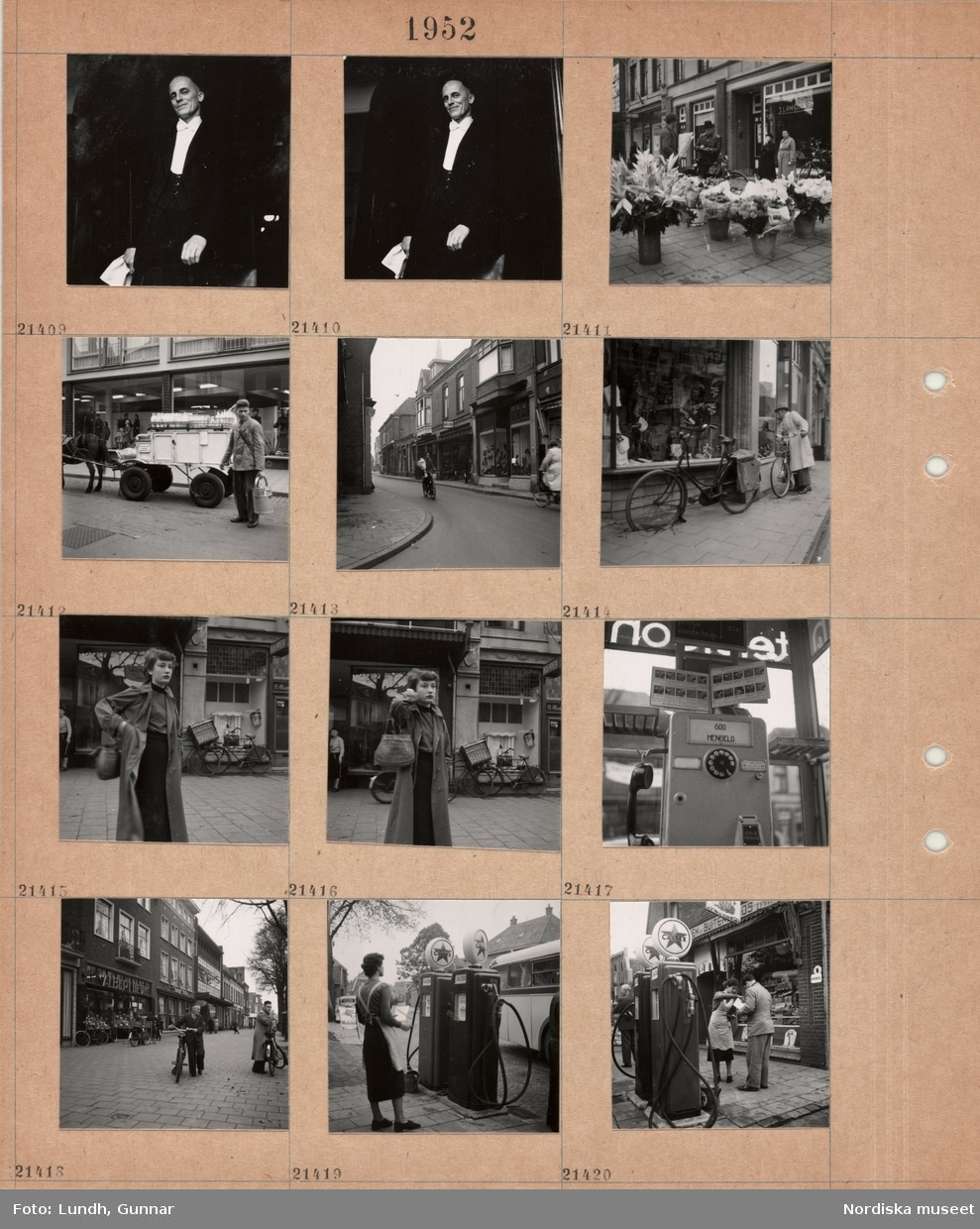 Motiv: (ingen anteckning) ;
"Holland 21400 - 444.", porträtt av en man som håller en serviett möjligen en servitör, hinkar med blommor till försäljning står på ett torg, en kvinna med en handväska, en telefonautomat med text "600 Hengelo", stadsvy med fotgängare med cyklar, en kvinna står vid bensinpumpar med text "Caltex".