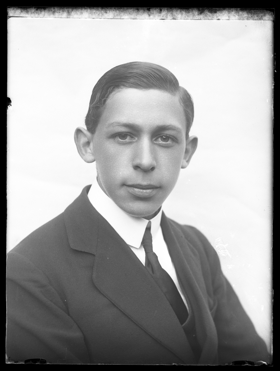Porträtt av Hugo Larsson i tredelad kostym, vit skjorta och slips.