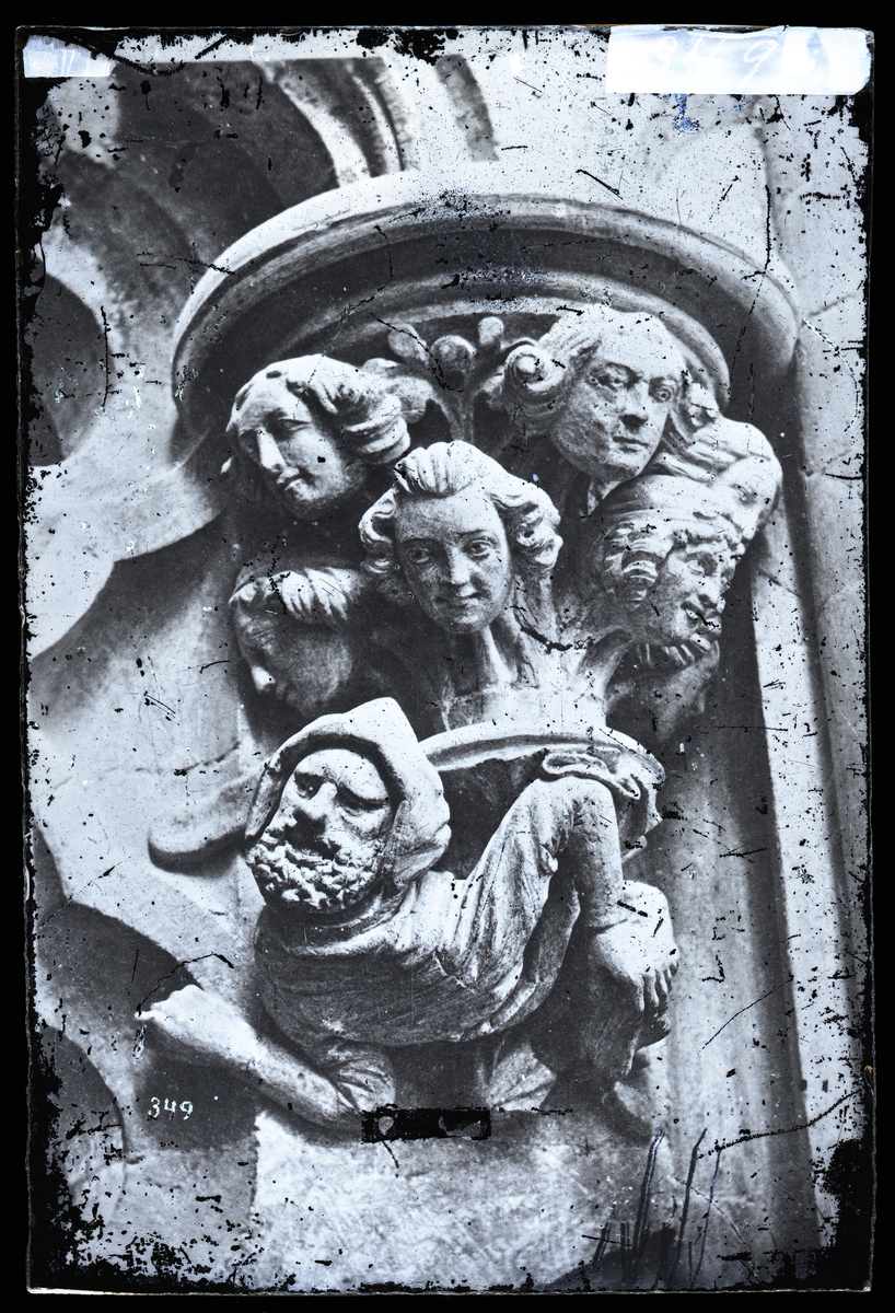 "Byggmesteren og hans svende" konsoll fra oktogonskranken i Nidarosdomen. Kapitel fra tidlig 1200-tall, skulpturen av byggmesteren fra etter 1328-brannen. Kapitel restaurert av Ole Laulo, senere endret av arkitekt Christie.