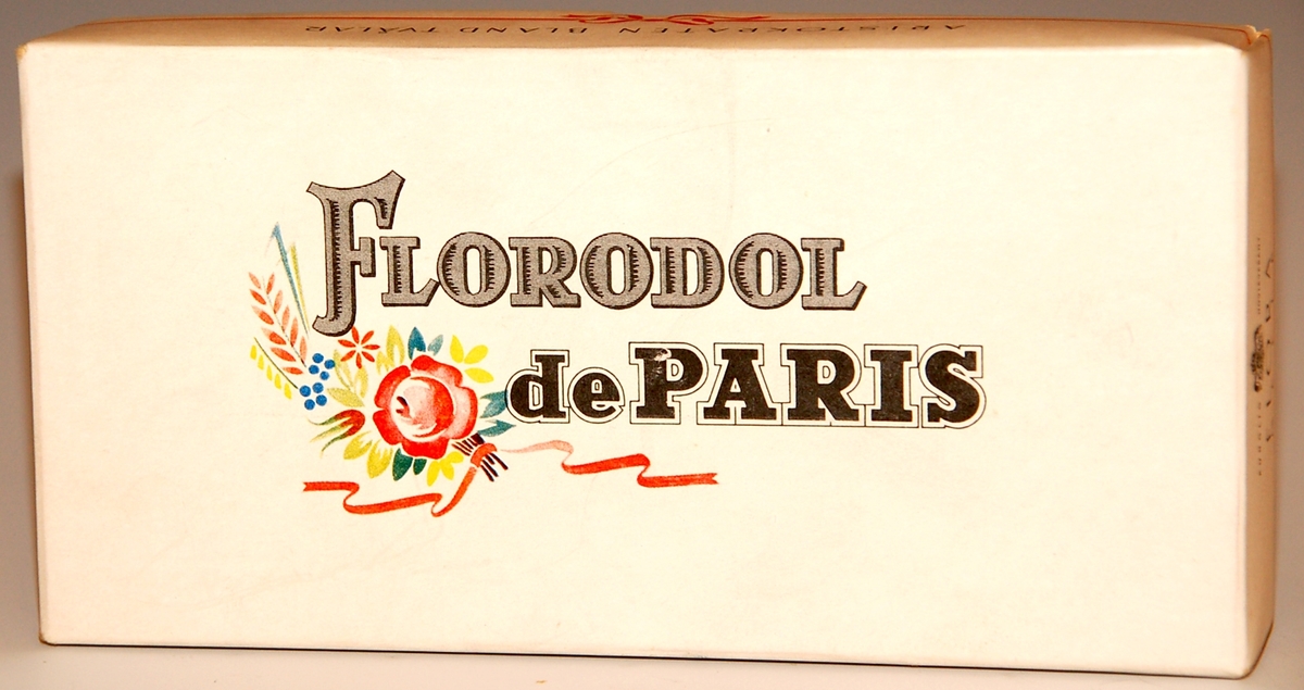 Förpackning av papper, innehållande två tvålar i papper.
Florodol de Paris.