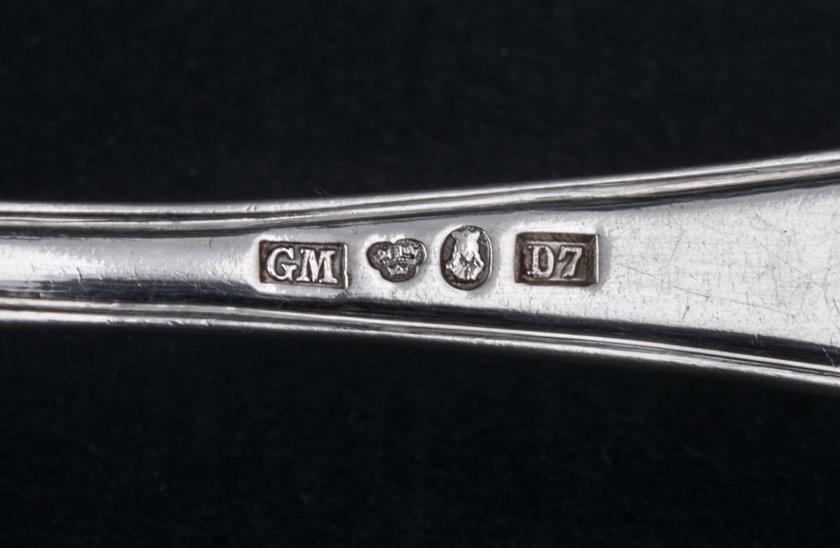 24 stycken dessergallar av silver. Linjeartat ornament på skaftet. Gammelfransk modell.
Stämplad: GM D7 Kontrollstämpel, Sthlm.
Monogram: PE