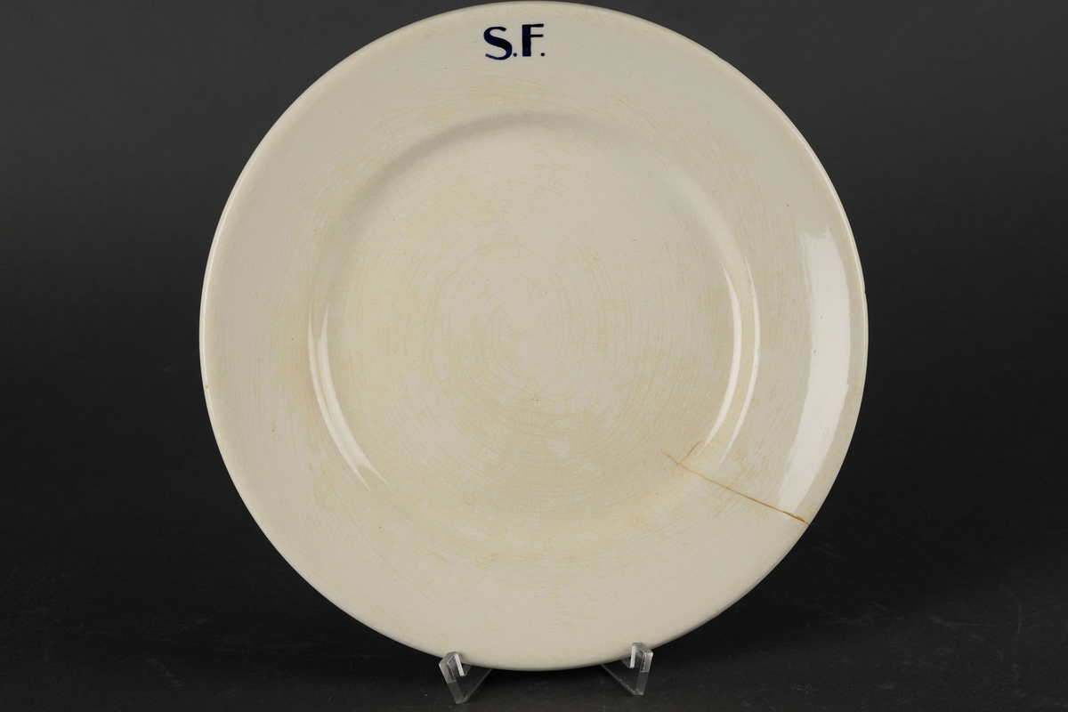 Hvit tallerken med påskriften "S.F."
