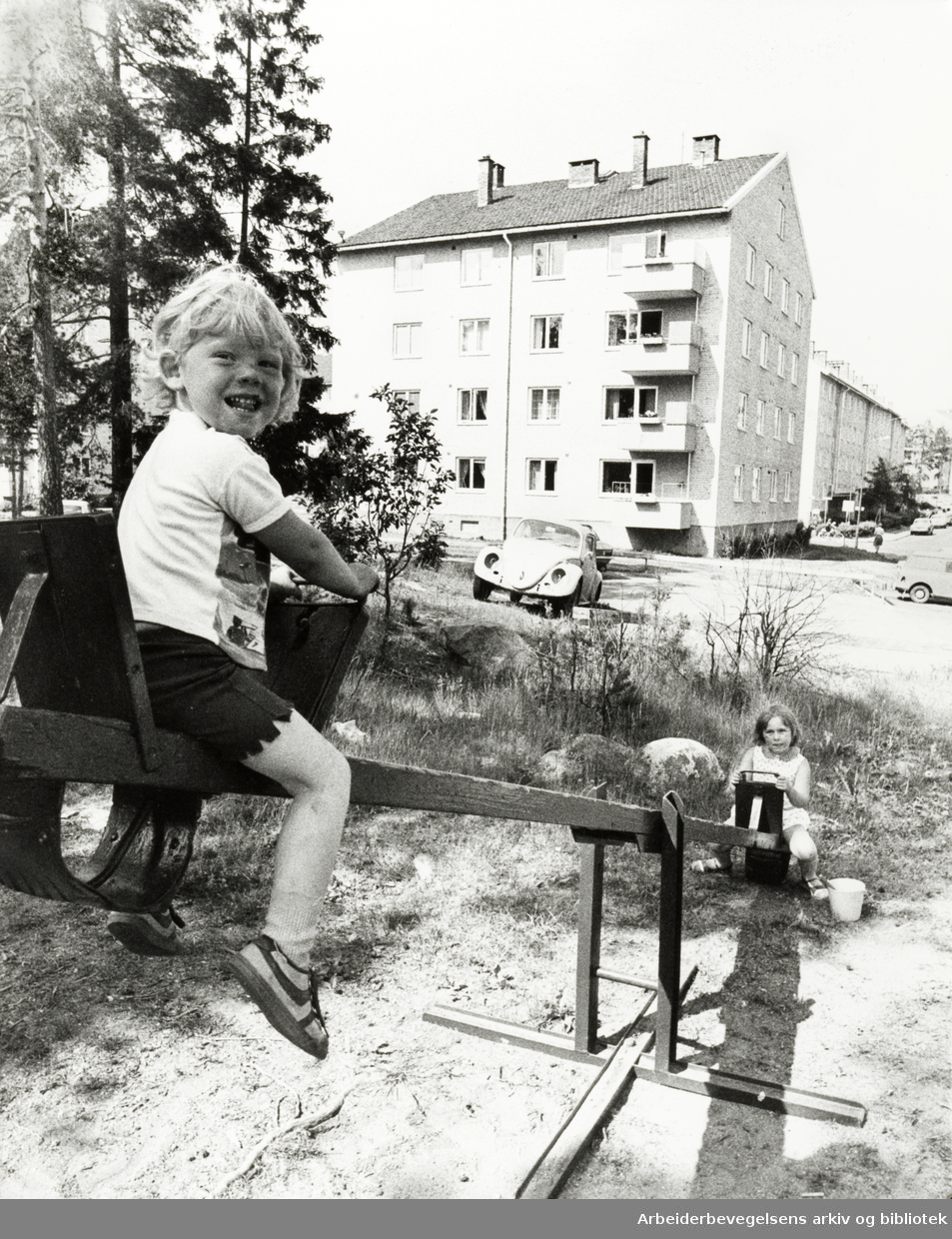Lambertseter. Rabben borettslag. Tommy Olsen (3 år) og Grethe Hansen (6 år) på dumphuska. 1. juli 1976
