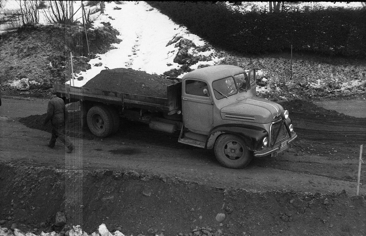 Tre bilder fra utvidelsen av daværende r.v.33 på Kraby 1960/1961. En lastebil, iflg. informant en tysk Ford FK4000, i ferd med å tømme fyllmasse rett ut for Odberg.