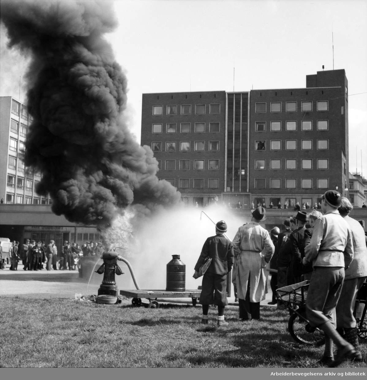 Brannvesenet demonstrerer slukking av oljebrann. Oslo hovedbrannstasjon, Arne Garborgs plass. Mai 1946.