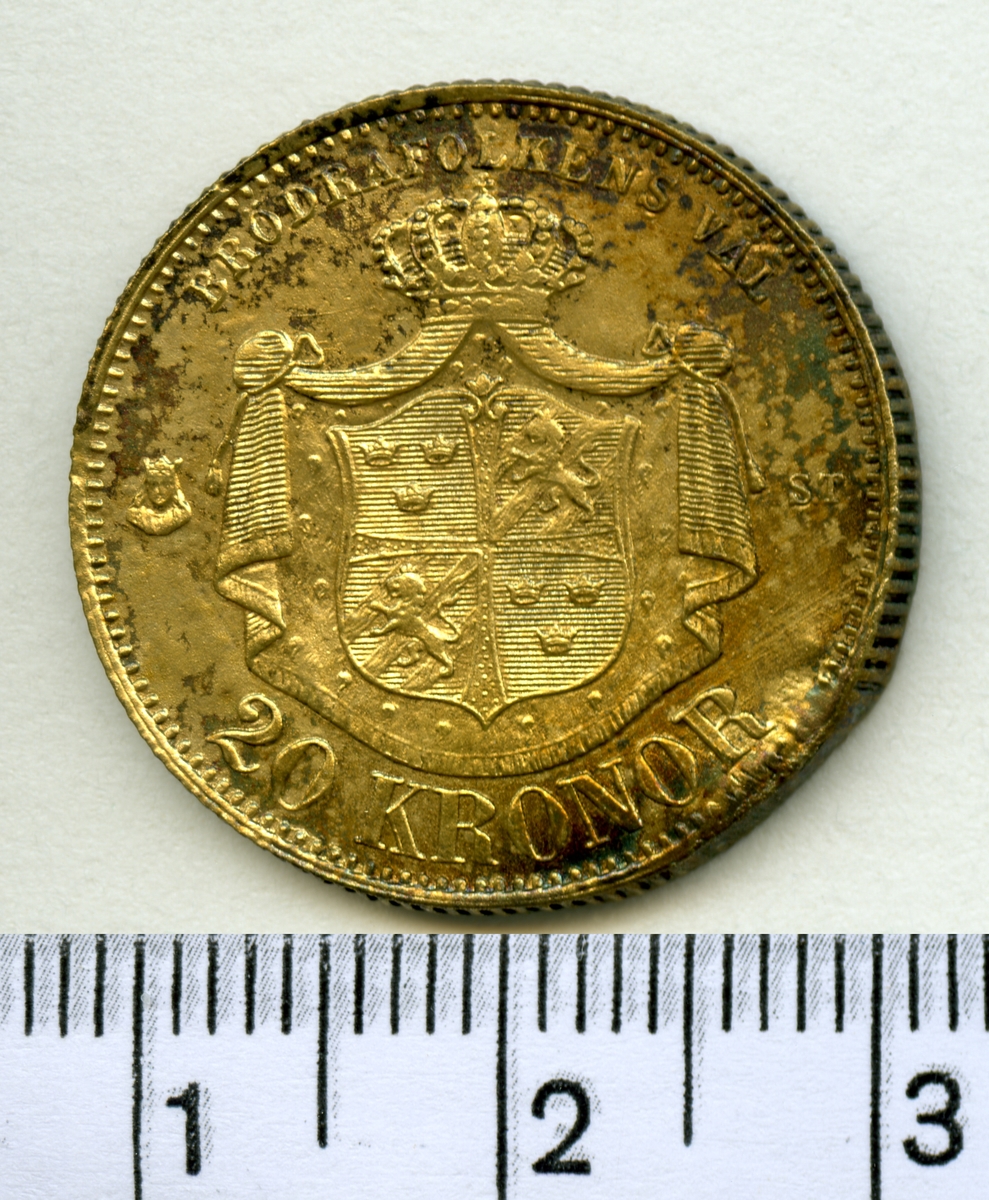 Mynt, sentida kopia av 20 kronor 1873, Oscar II.

Myntet är i 2 delar som visar fram och baksida.
