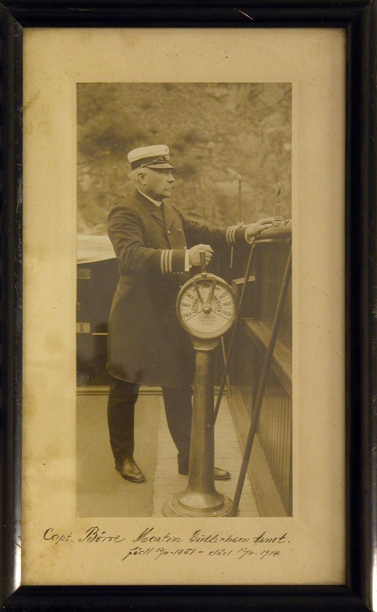 Kaptein Børre Martin Gullichsen Arnet (1851-1914) poserende på dekk ved siden av maskintelegrafen.