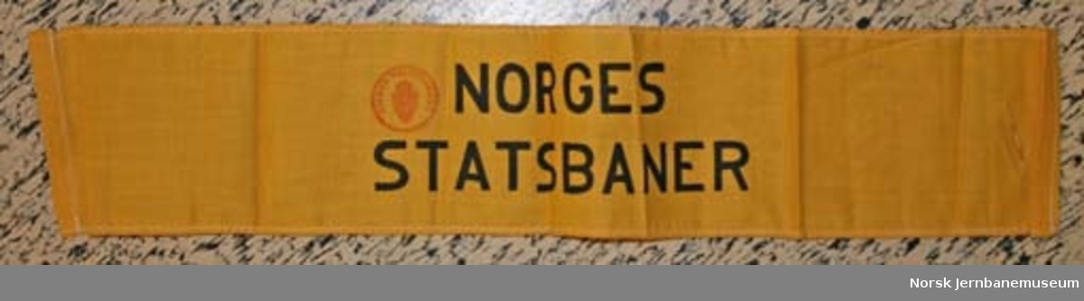 Armbind med teksten "NORGES STATSBANER"