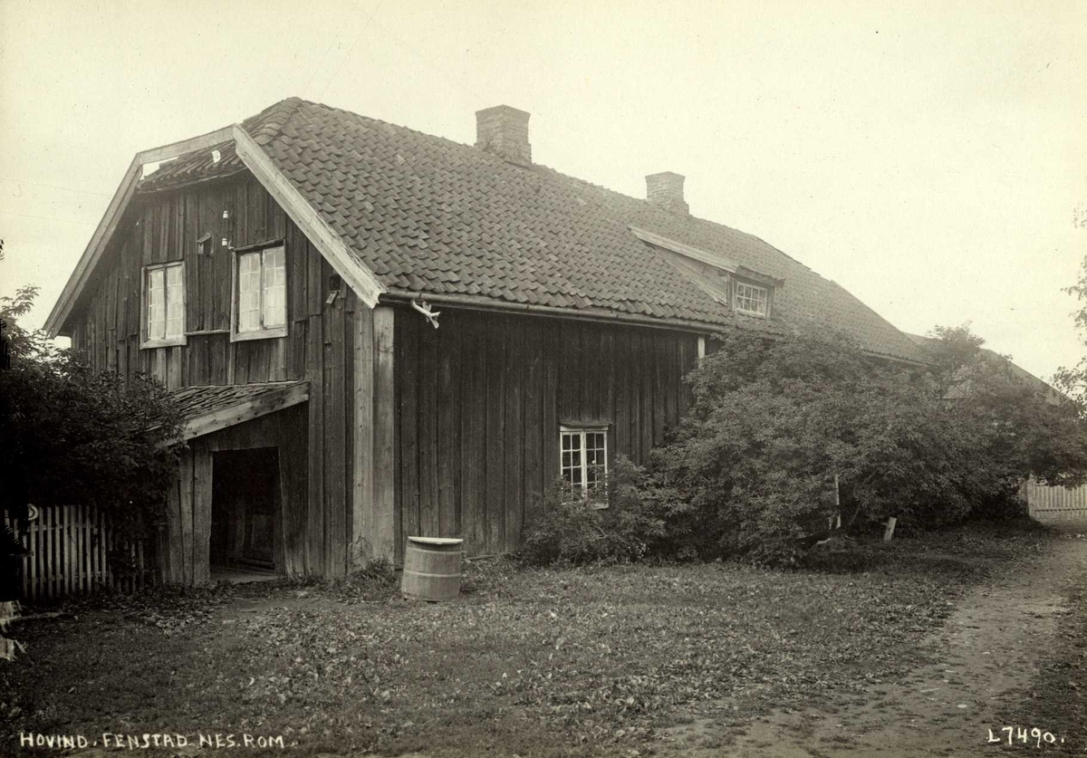 Hovind, Fenstad, Øvre Romerike, Nes, Akershus. Våningshus sett mot kjøkkendør, med tønne under takrenne og delvis gjemt bak busker.