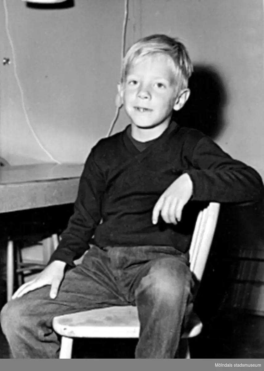 En pojke som sitter på en stol. Holtermanska daghemmet 1953.
