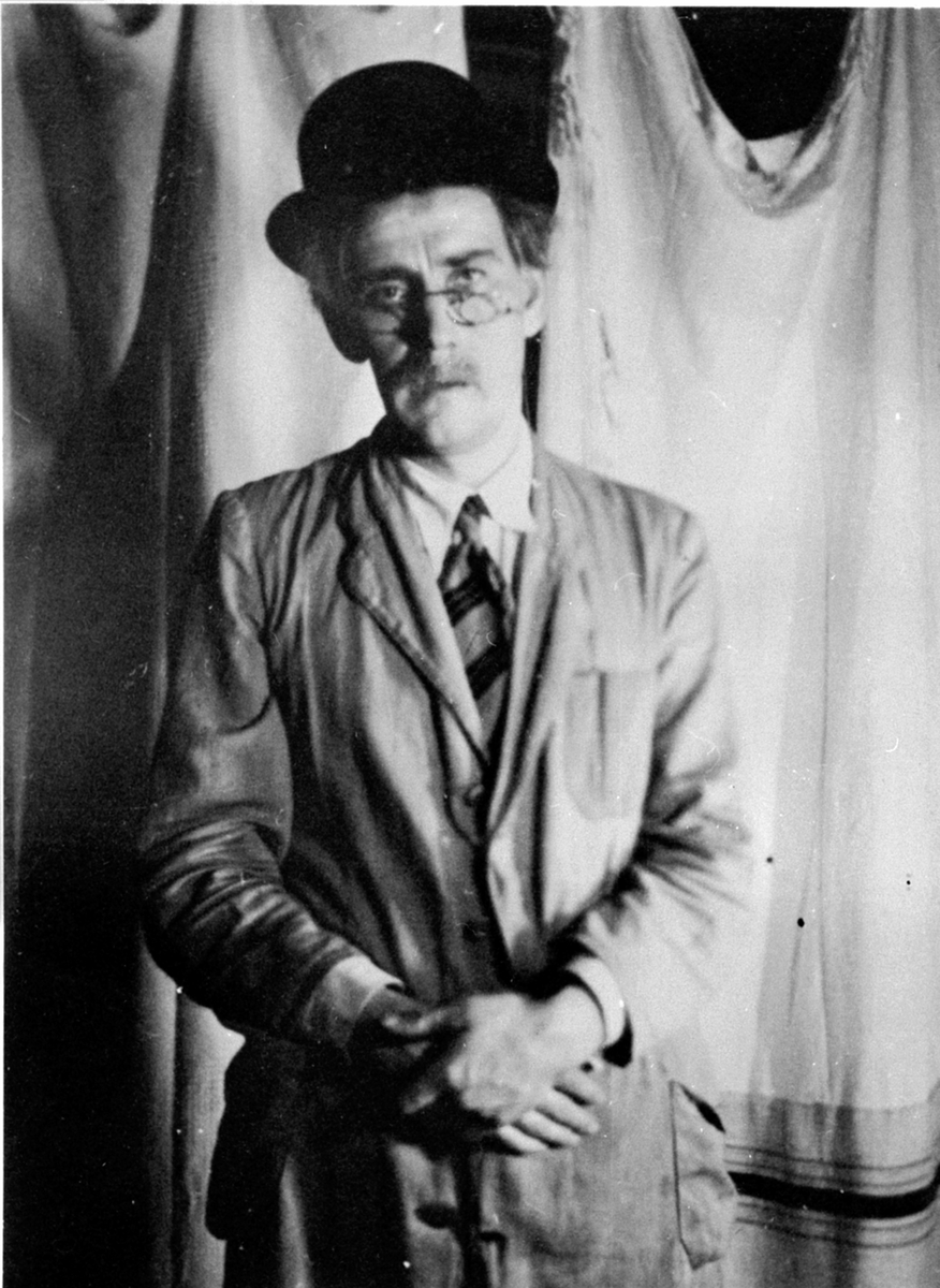 Sem Småbrukslærerskole,Alf Prøysen spiller revy, mann med hatt, frakk og briller.